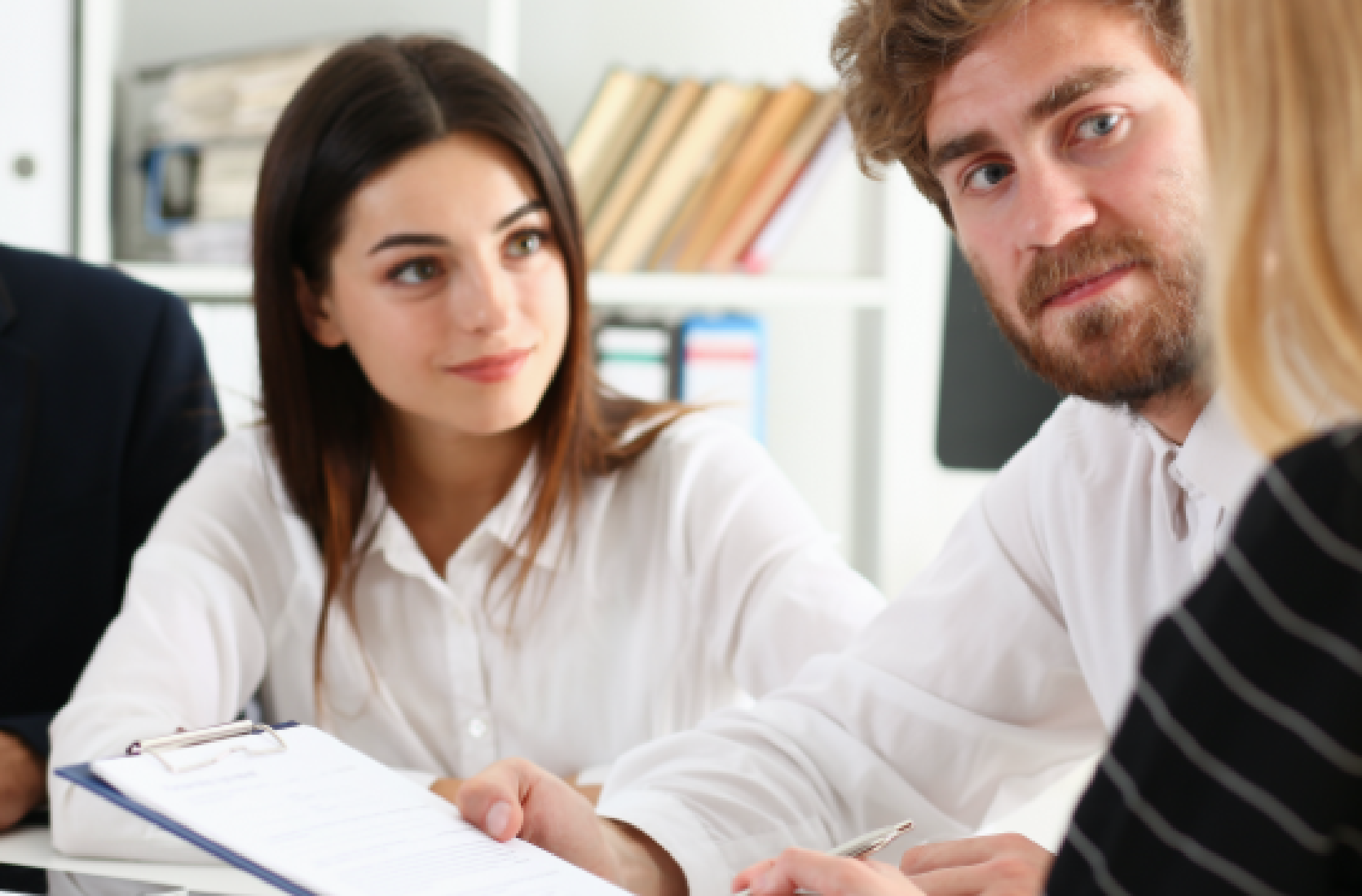 Clients listening to a lawyer who is handing them documents