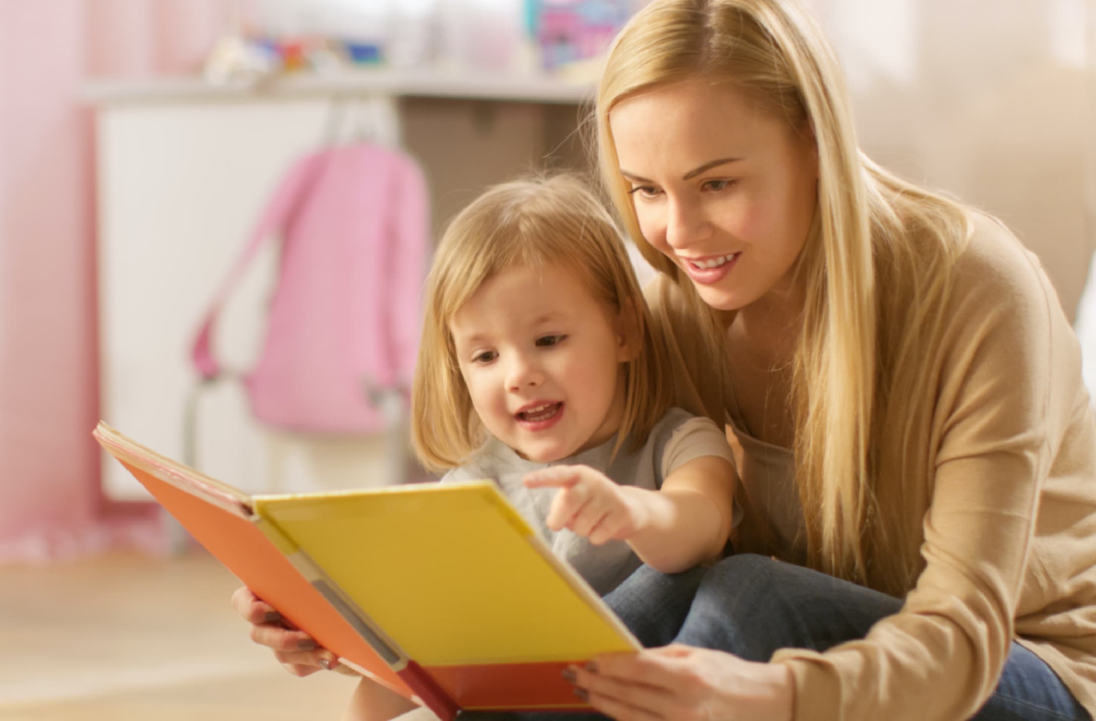 Mum reading a book to her toddler